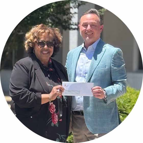 Lori Mathes and Bill Cable check presentation